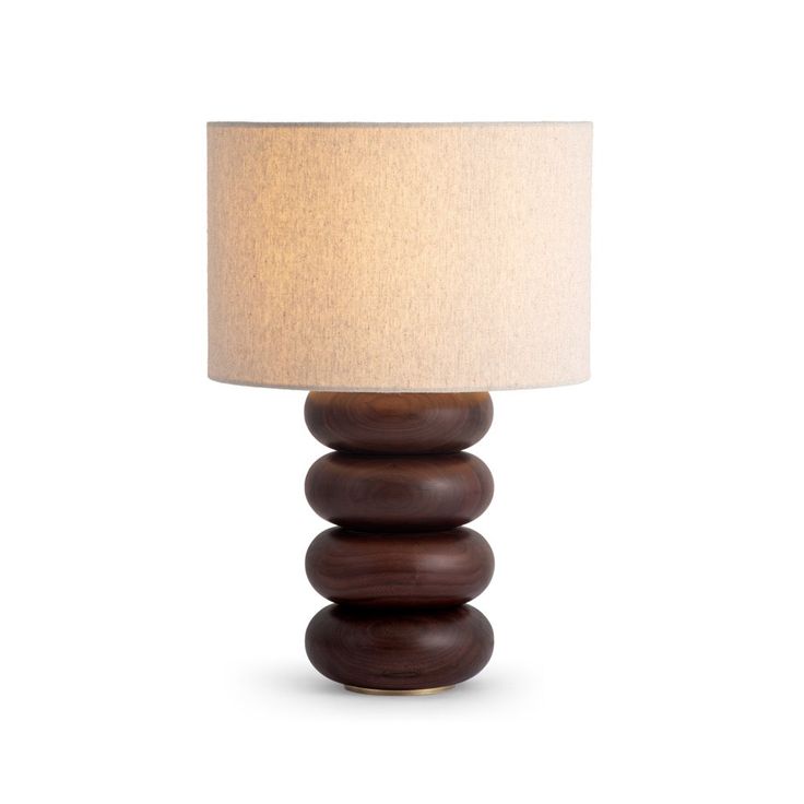 a wooden lamp with a white shade on it's side and a brown base