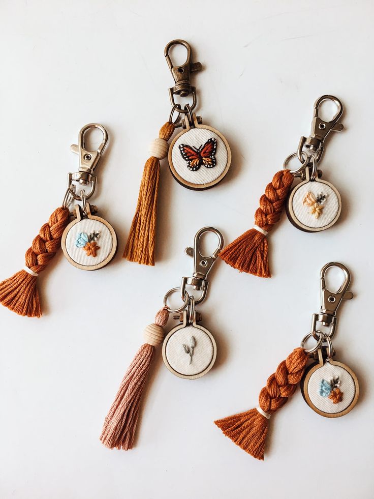 six keychains with tassels and butterflies on them