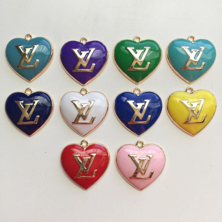 the louis vuitton heart pendants are all different colors and have gold letters on them