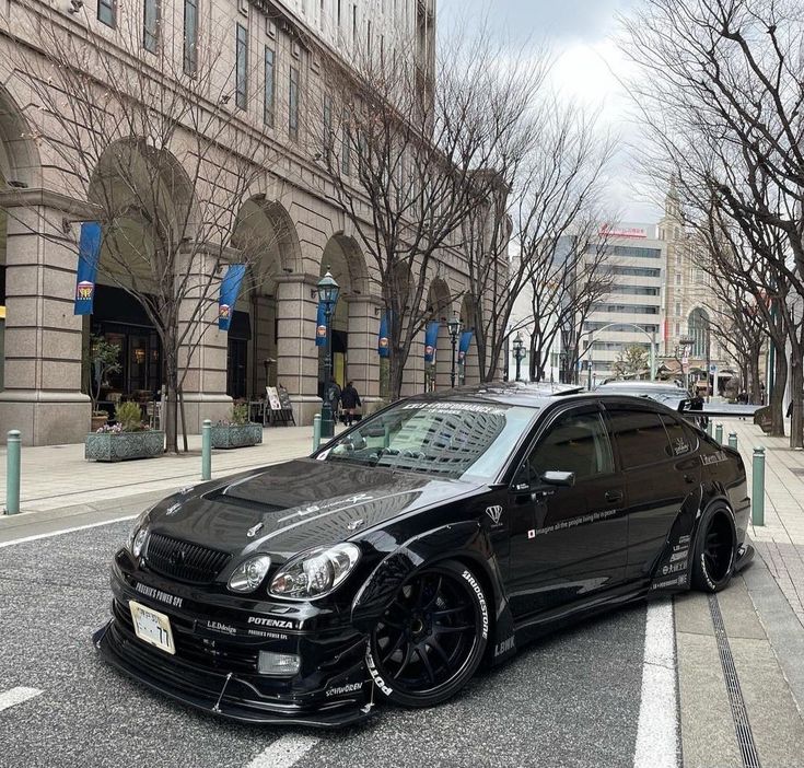 a black car is parked on the street