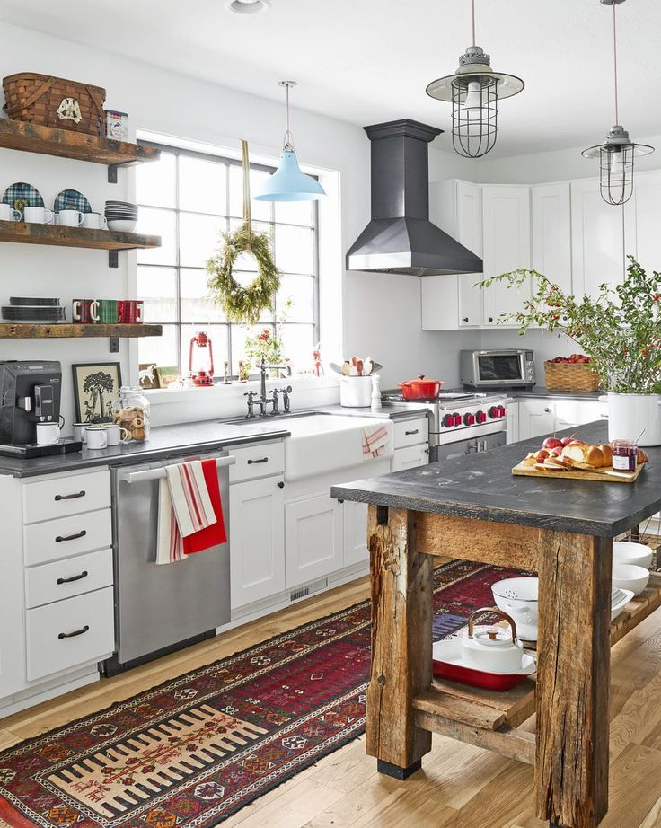 a kitchen with white cabinets and an island in front of a stove top oven next to a sink