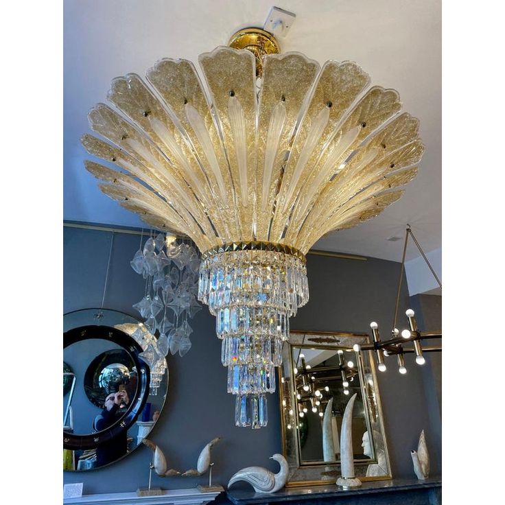 a chandelier hanging from the ceiling in a room with mirrors and other items