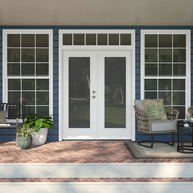 a porch with chairs, table and potted plants on the front steps next to it