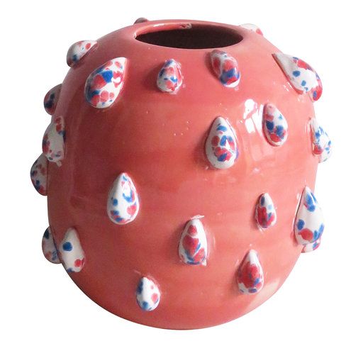 a red vase with white and blue decorations on it's sides, against a white background