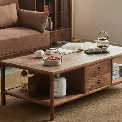 a living room with a couch, coffee table and bookshelf