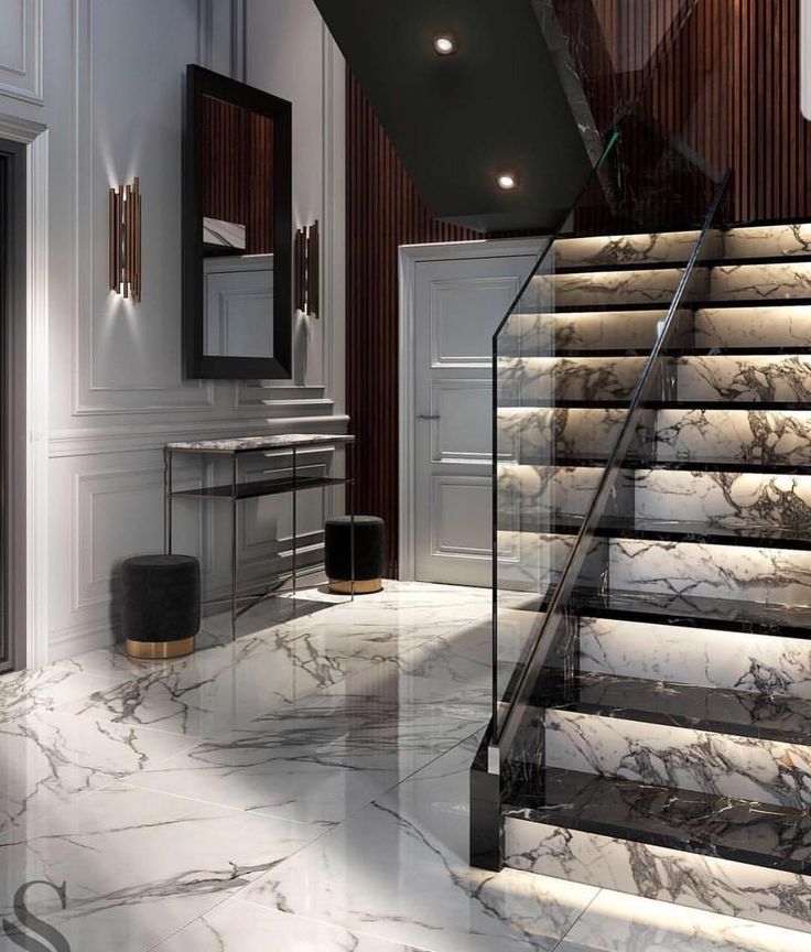 an elegant staircase with marble floors and walls