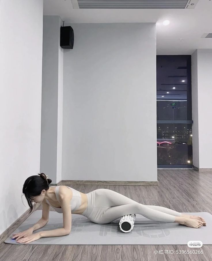 a woman is doing yoga on the floor