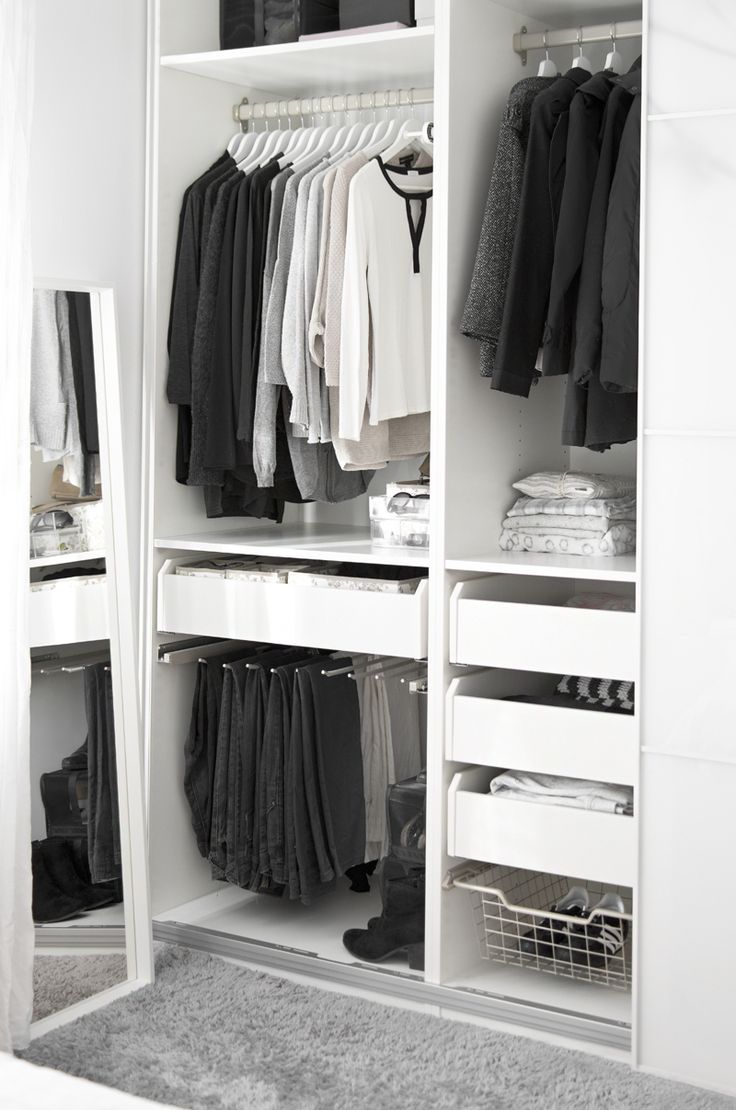 a white closet filled with lots of clothes