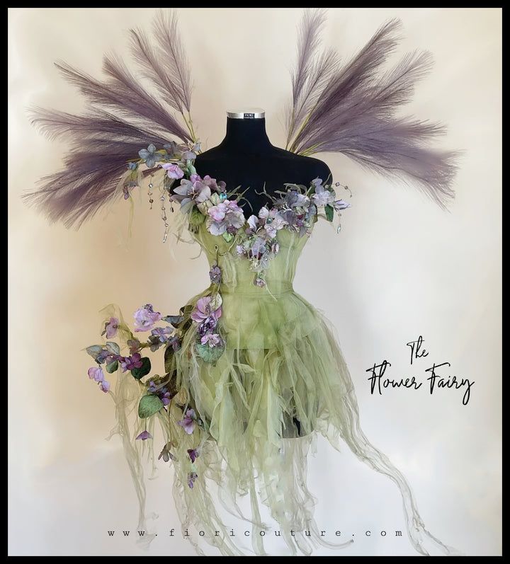 a mannequin with flowers and feathers on it