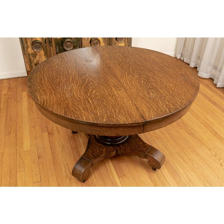 a wooden table sitting on top of a hard wood floor