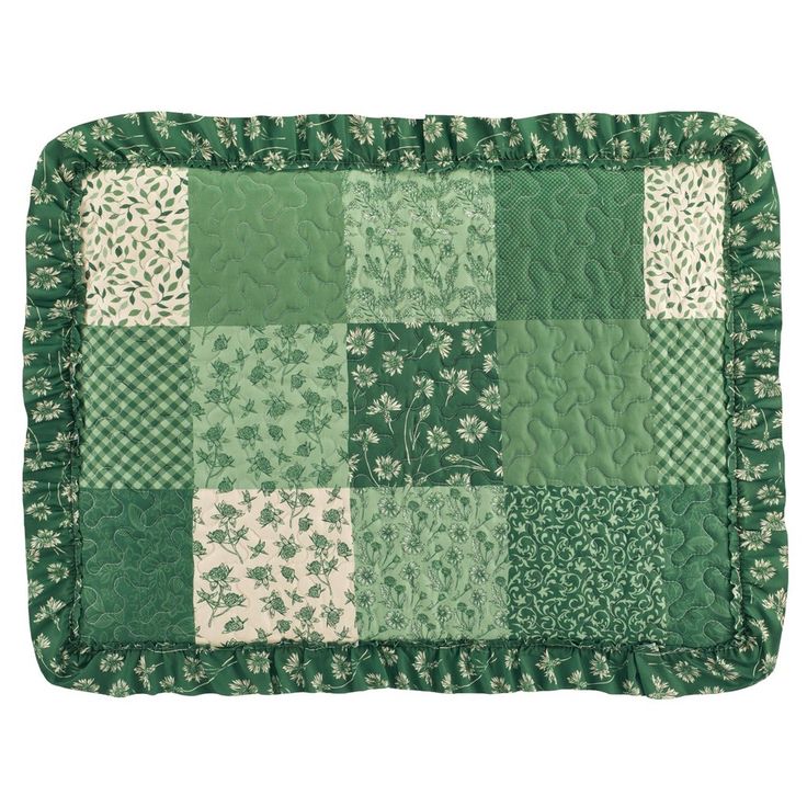 a green and white patchwork quilted placemat