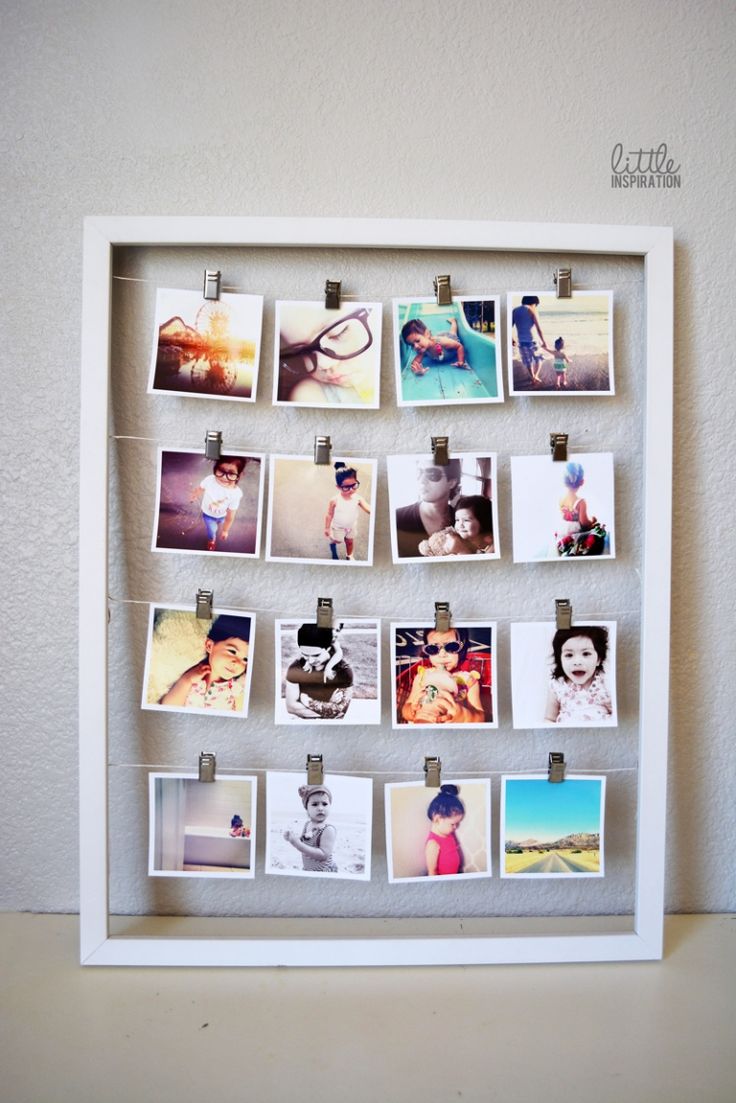 a white frame with photos pinned to it