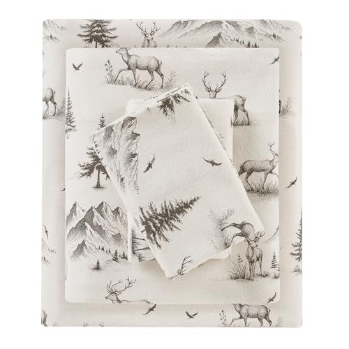 two sheets with deer and trees on them, one is folded in front of the other