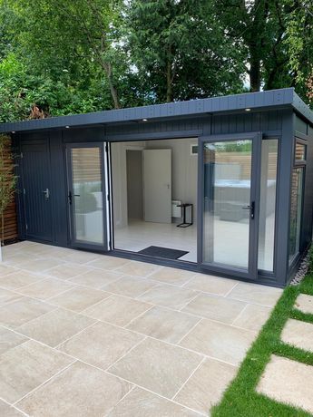 a garden room with sliding glass doors on the outside