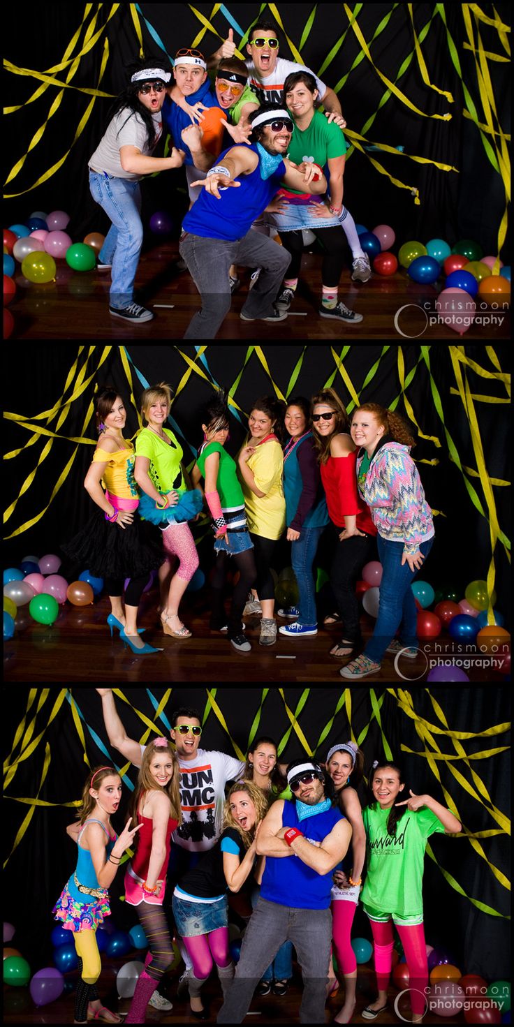 a group of people posing in front of balloons and streamers