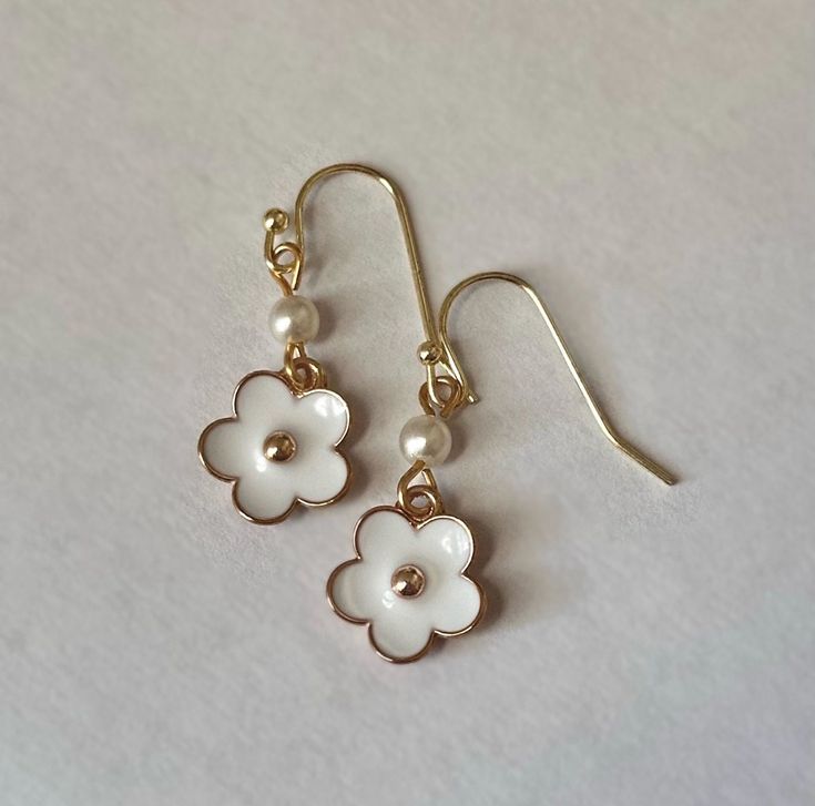 These gold earrings feature a pearl bead and enamel flower. They are the perfect mix class and kitsch! Total drop measures 1.125 inches. Free US shipping!  Buy two items and get $3 off with code BUYTWO Follow on Instagram @FawnAndHoney for updates! www.instagram.com/FawnAndHoney Flower Dangle Earrings, Follow On Instagram, Enamel Flower, Gold Flower, Gold Flowers, Pearl Beads, Kitsch, Favorite Jewelry, Jewelry Earrings Dangle