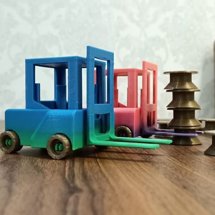 a toy truck sitting on top of a wooden table next to other small toys and knobs