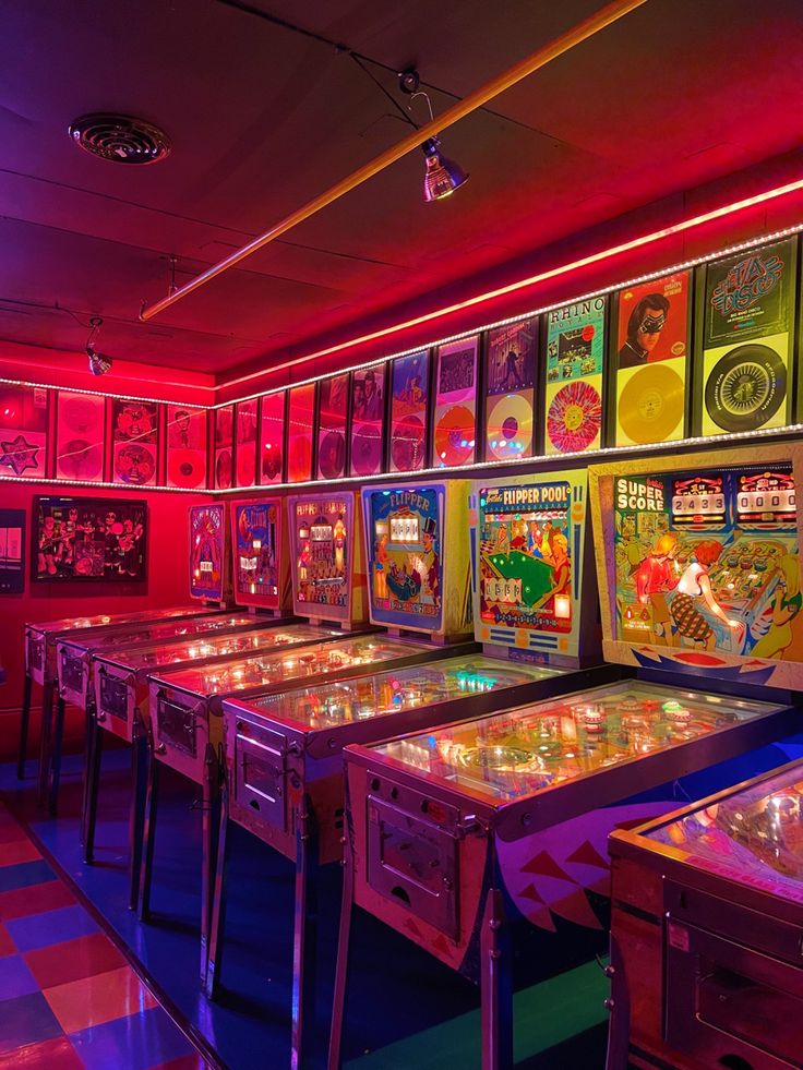 several pinball machines in a brightly lit room