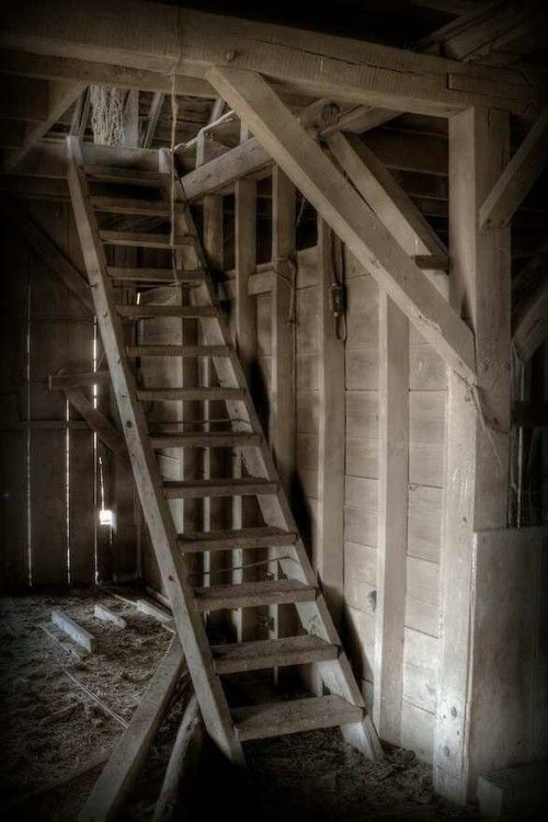 an old wooden staircase in a barn