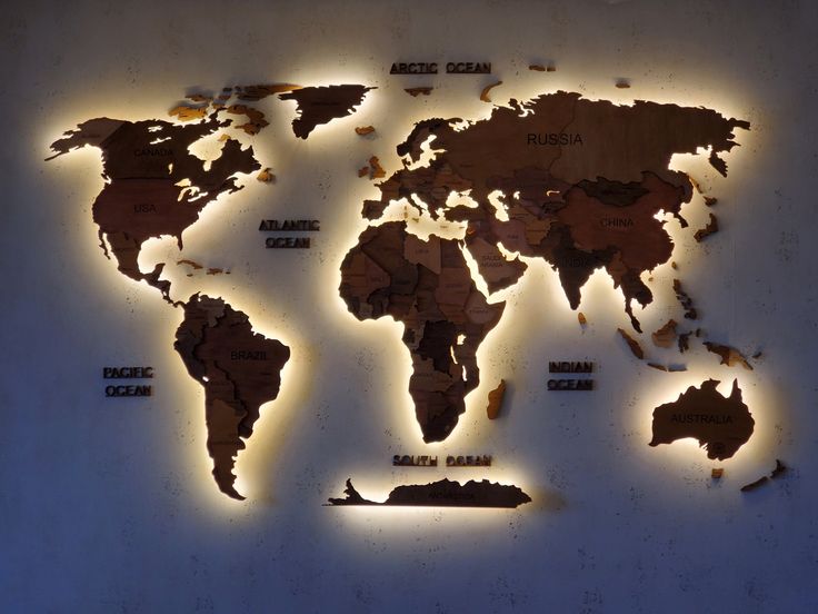 a world map is shown with lights on the wall and below it are words that spell out countries