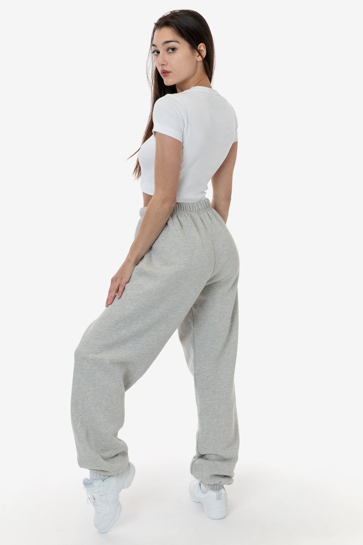 We've taken our new and bestselling Flex Fleece Sweatpant and made it in a slightly heavier, cotton fleece with heather finishes. This unisex pant features an adjustable drawstring and an elastic hem at the ankle. This fleece is soft and comfortable. Perfect for post workout, lounging at home or a trip to the grocery store. Pair with a bodysuit or crop top for a casual look or go bold with the matching Cotton Fleece Half Zip Cropped Pullover. These sweatpants feature a high waist fit that accent Jojo Pose, Cute Sweats, Sweatpants And Hoodie, Sweatpants For Women, La Outfits, Comfy Sweats, Comfy Sweatpants, Sweatpants Style, Sweatpants Outfit