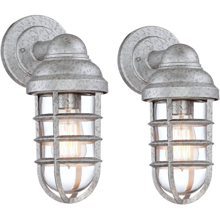 The Marlowe collection of outdoor lighting offers a creative combination of nautical style and industrial design. This set of two metal outdoor wall lights features a stylish cage design with a narrow glass shade inside. The steel construction is made to look galvanized for an urban-rustic look. Perfect for a patio space or garage area, these versatile fixtures can be installed pointing up or down. Deck House, Industrial Outdoor, Outdoor Wall Light Fixtures, Outdoor Party Lighting, Steel Cage, House Yard, House Deck, House With Porch, Wall Ceiling Lights