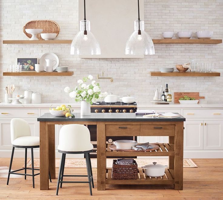 a kitchen island with two stools next to it