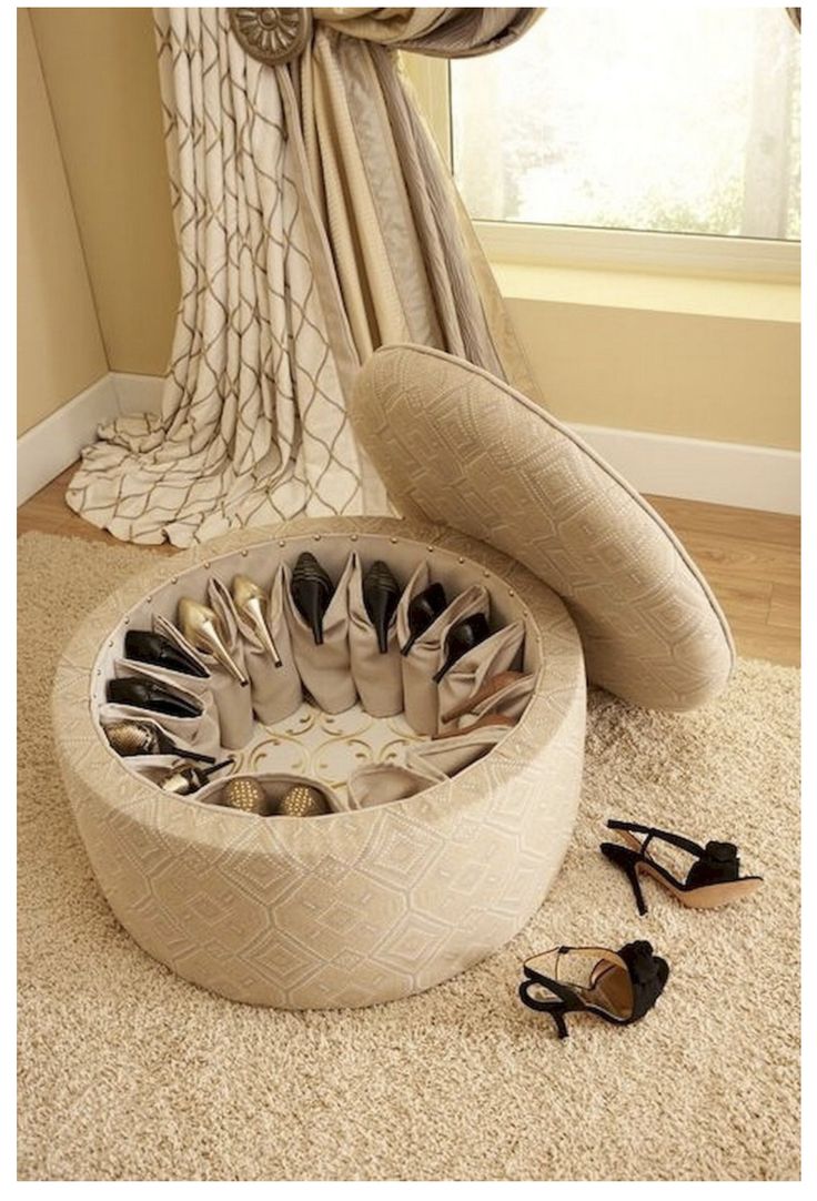 a round foot stool sitting on top of a rug next to a pair of shoes