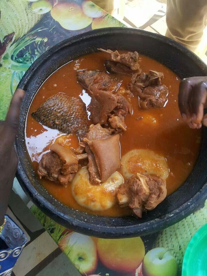 a bowl filled with meat and apples on top of a table