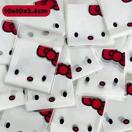 many hello kitty bags are stacked together on top of each other with black and white polka dots