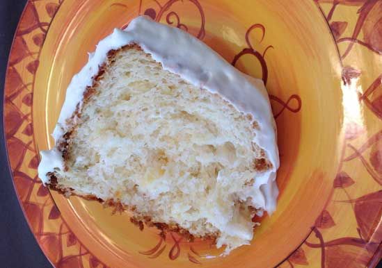 a piece of cake sitting on top of an orange and yellow plate with white frosting