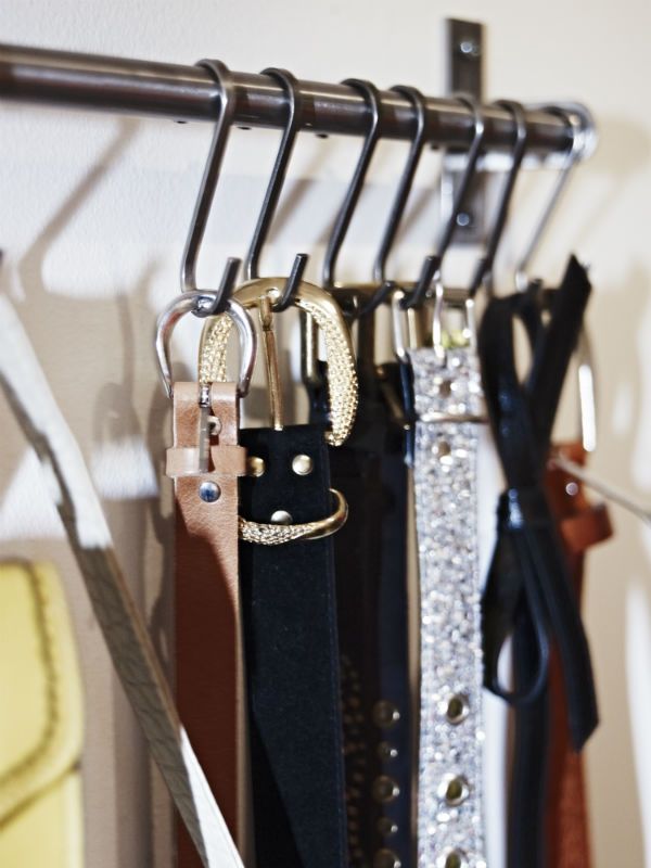 there are many different belts hanging on the rack