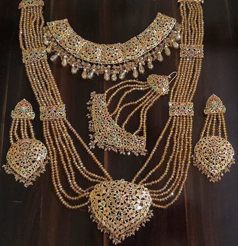 an elaborate necklace and earring set on display