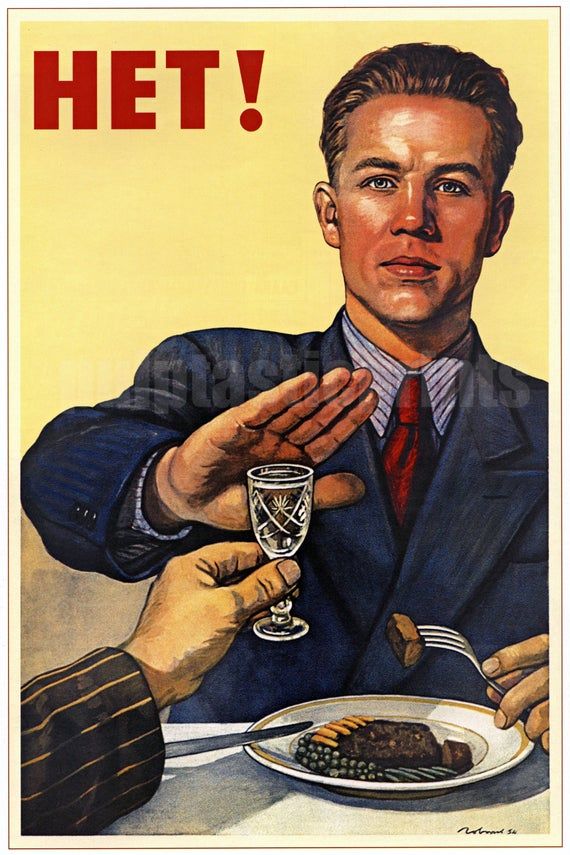 a man holding a glass with food on it