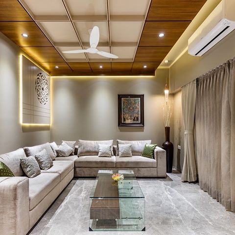 a living room filled with furniture and a flat screen tv mounted on the wall next to a window