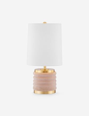 a pink and gold table lamp with a white shade on the top, against a white background