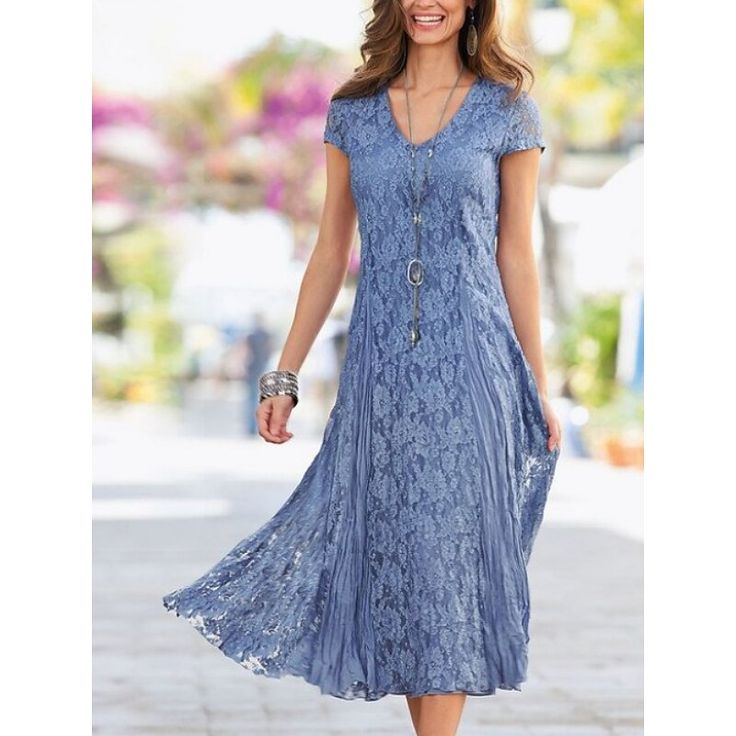 a woman in a blue dress is walking down the street with her hand on her hip