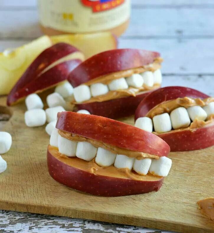 apple peanut butter teeth on a cutting board