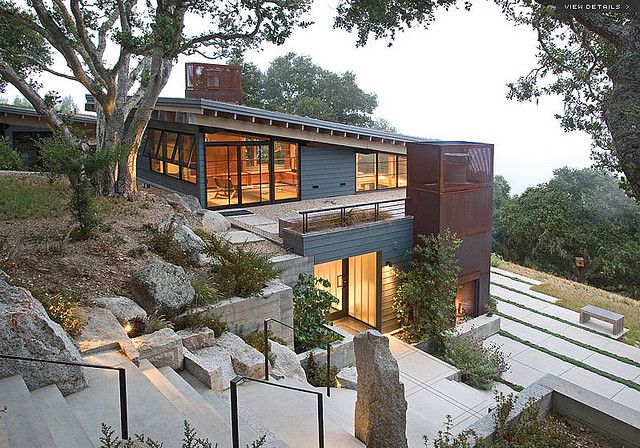 a modern house on top of a hill