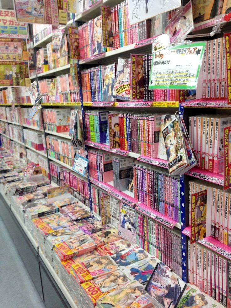 many magazines are on display in a store with shelves full of books and magazines behind them