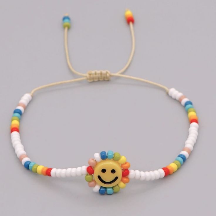 a beaded bracelet with a smiling face on the front and multicolored beads