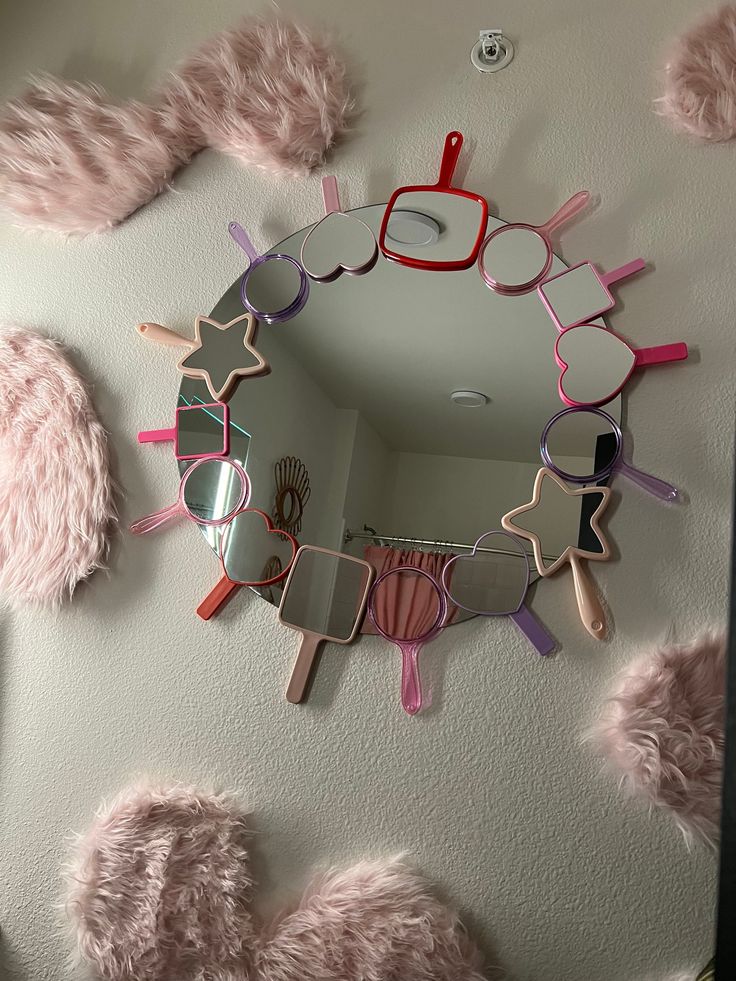 there is a mirror that has some pink hair on it and glasses hanging from the wall