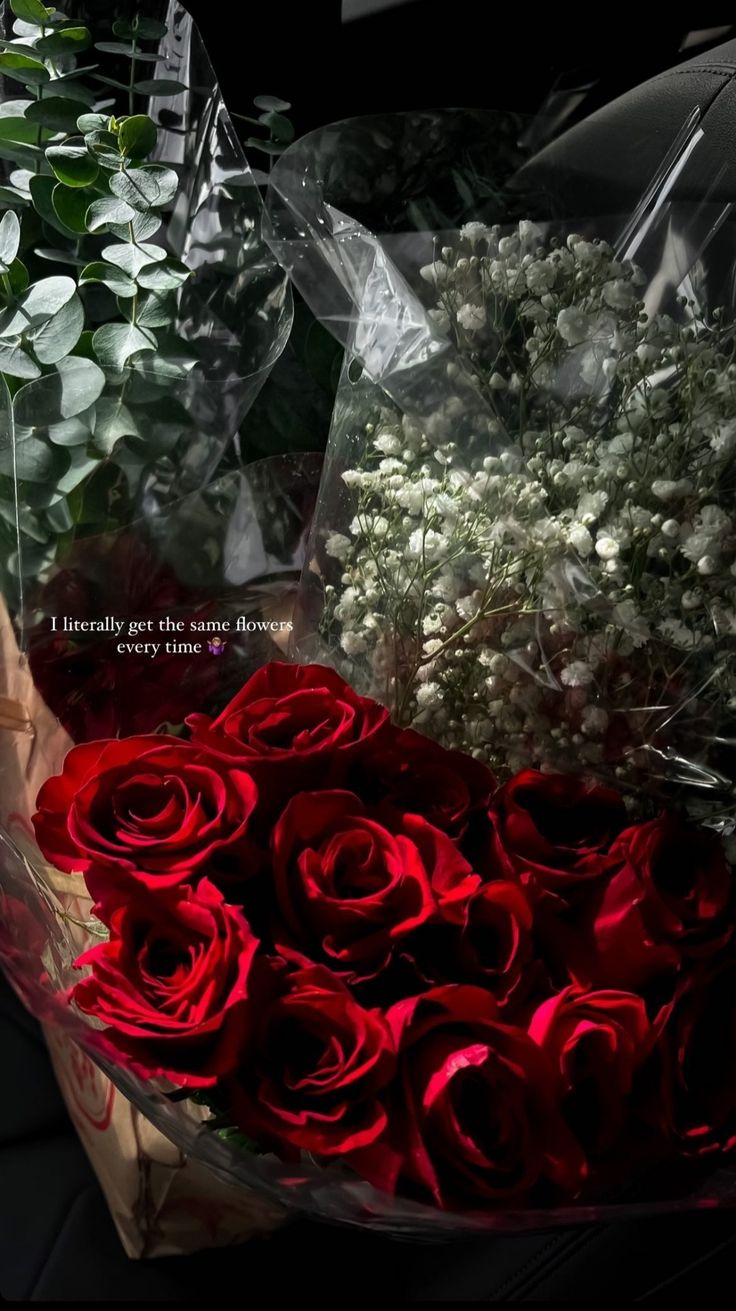 a bouquet of red roses sitting on top of a table