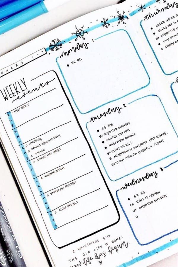 an open planner with notes and pens on it