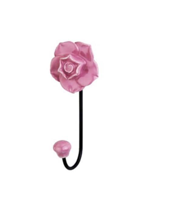 a pink flower on a black hook