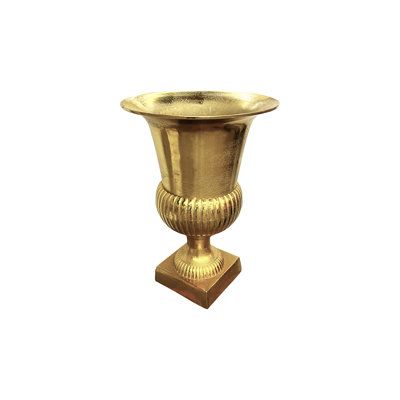 a gold vase sitting on top of a wooden stand