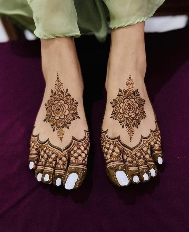 the feet are decorated with henna and flowers