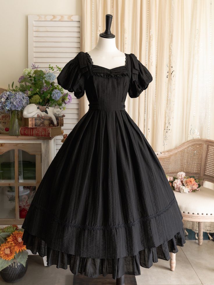 This price includes a dress and a black bowknot hairclip (not for sale).  Embrace timeless elegance with this enchanting Black Puff Sleeves Classic Lolita Princess Tea-Length Dress. Designed for the true Lolita aficionado, this dress features delicately puffed sleeves and a flattering tea-length skirt that exudes sophistication and charm. The back boasts a comfortable shirring detail, ensuring a perfect fit for all body types. Whether you're attending a tea party, a cosplay event, or simply indu Dark Tea Party Outfit, Vintage Bow Dress For Costume Party, Vintage Black Puff Sleeve Dress, Vintage Dresses 50s 1950s Fashion Classy, Halloween Costumes With A Black Dress, Black Dress For Halloween, Victorian Black Dress, Black Witchy Dress, Casual Princess Dress