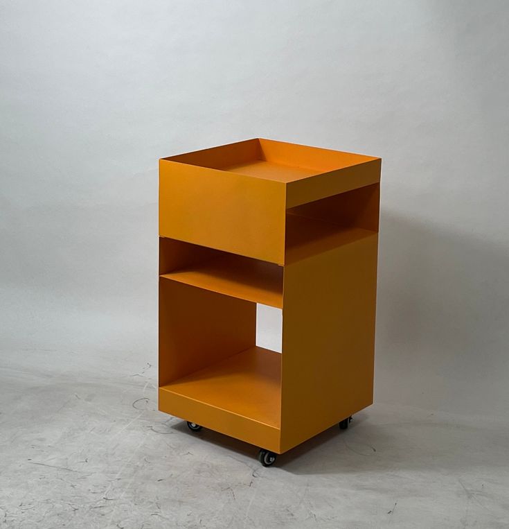 an orange shelf sitting on top of a white floor