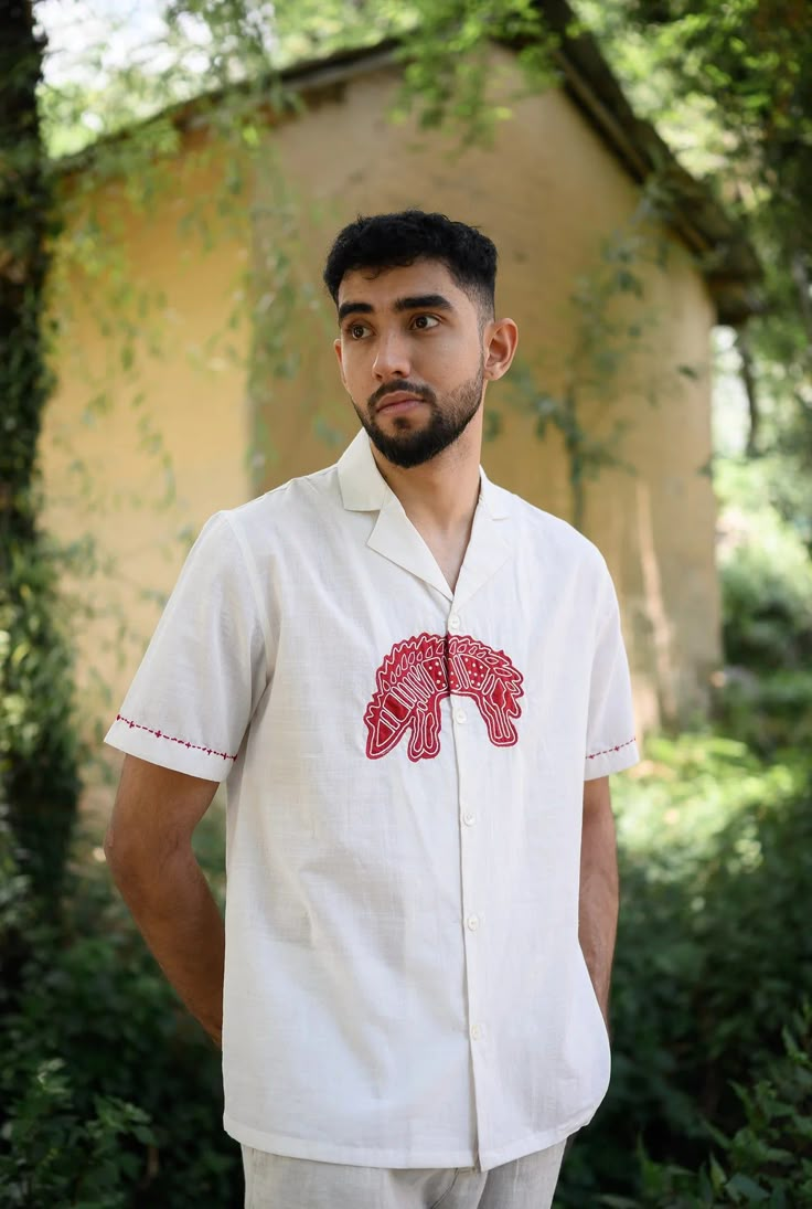 We have a crush on this shirt, because of its kooky hand detailed hand embroidered applique. Crafted in cotton, it also features embroidery details on the sleeves. This product is handcrafted in Pune, India. Subtle variations in patterns are natural to this process. We believe this makes each creation unique and charming. Men Shirts Embroidery, Mens Shirt Illustration, Cloth Painting Ideas, Men Embroidery Shirts, Painted Shirts Diy, Embroidery Designs Shirts, Shirt Embroidery Ideas For Men, Embroidery Shirt Ideas, Hand Embroidery On Shirt